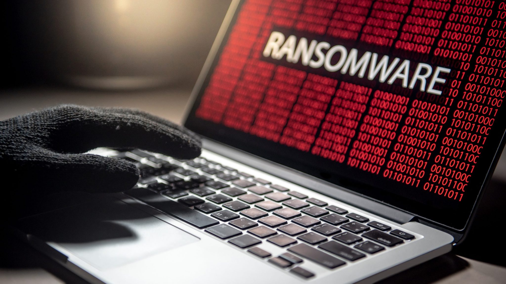 Hacker,Hand,On,Laptop,Computer,Keyboard,With,Red,Binary, ransomware