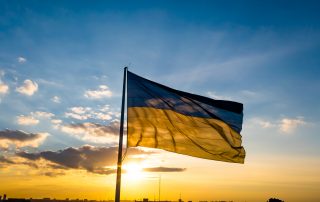 Flag of Ukraine against the backdrop of sunrise. Yellow-blue flag of independent Ukraine.