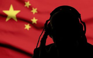Silhouette of a man in headphones, secret agent eavesdropping, spy and scout, China flag, backlight