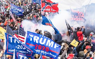 Washington, DC - January 6, 2021: Smoke rises after explosure police used pepper-spray ball gun against Pro-Trump protesters rally around Capitol building before they breached it and overrun it