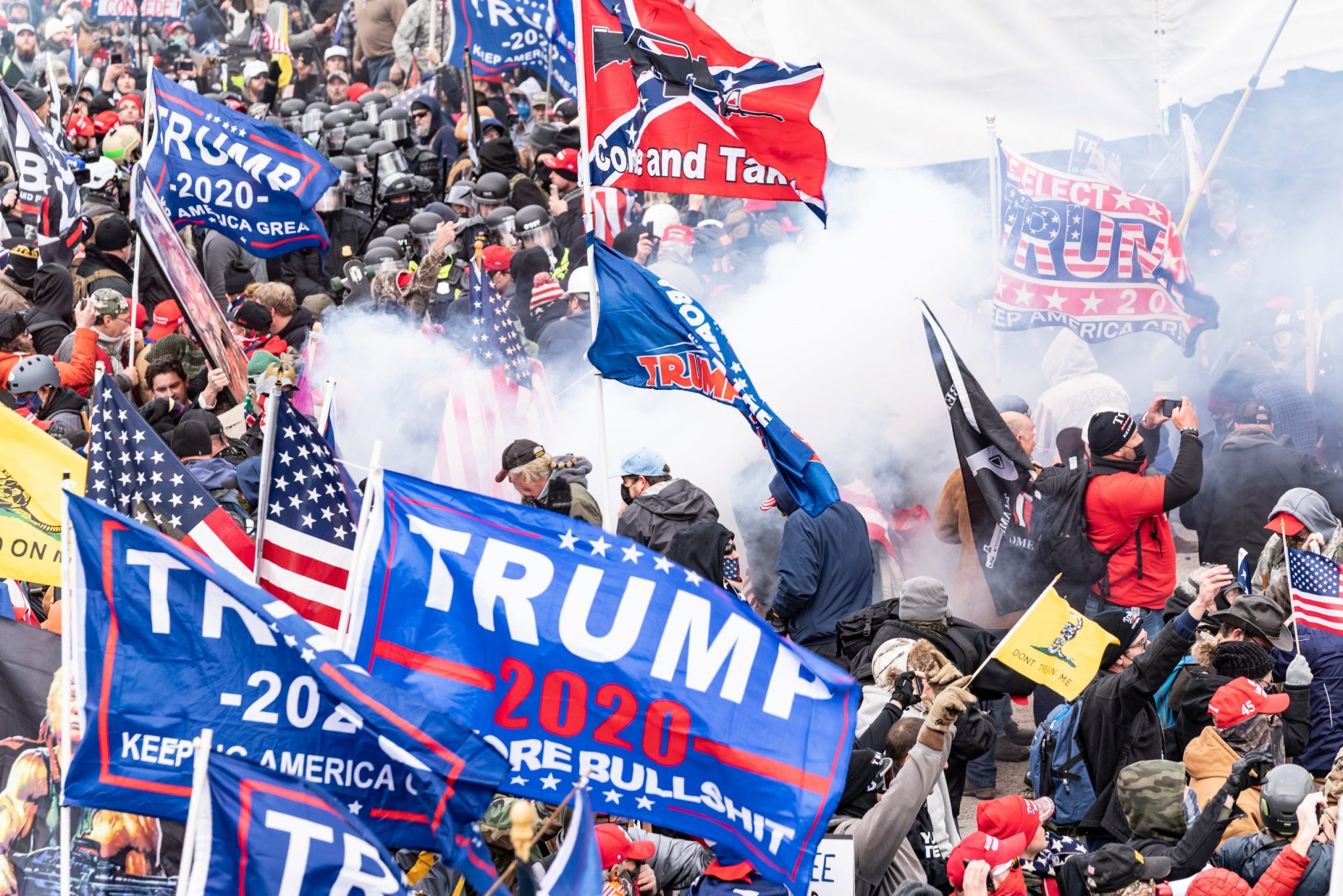 Washington, DC - January 6, 2021: Smoke rises after explosure police used pepper-spray ball gun against Pro-Trump protesters rally around Capitol building before they breached it and overrun it