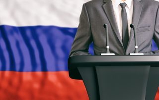 Businessman or politician making speech on Russia flag background
