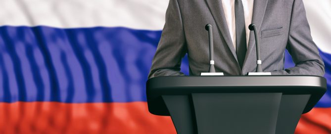 Businessman or politician making speech on Russia flag background