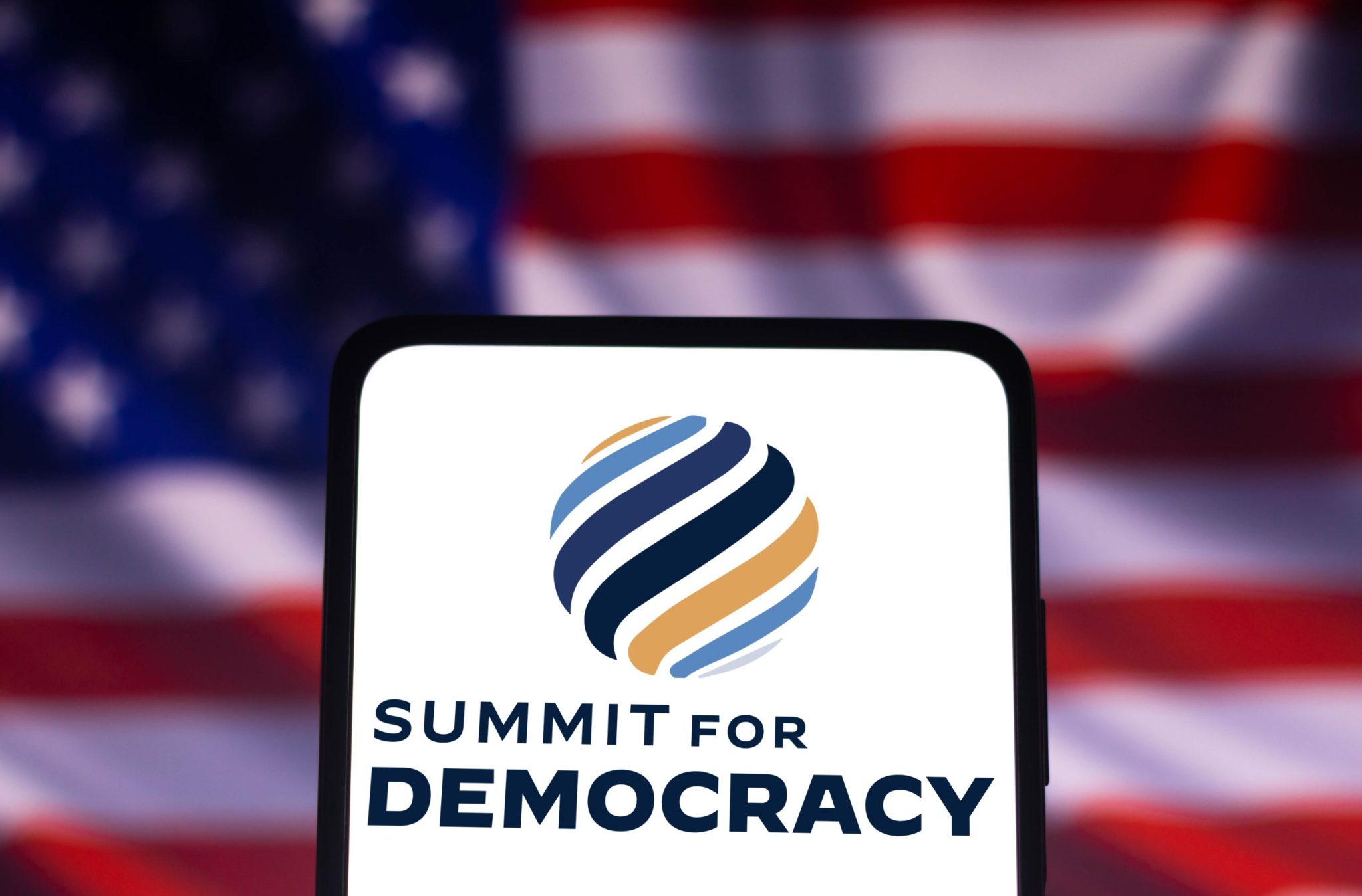 December 9, 2021, Brazil. In this photo illustration the Summit for Democracy logo seen displayed on a smartphone with American flag in background