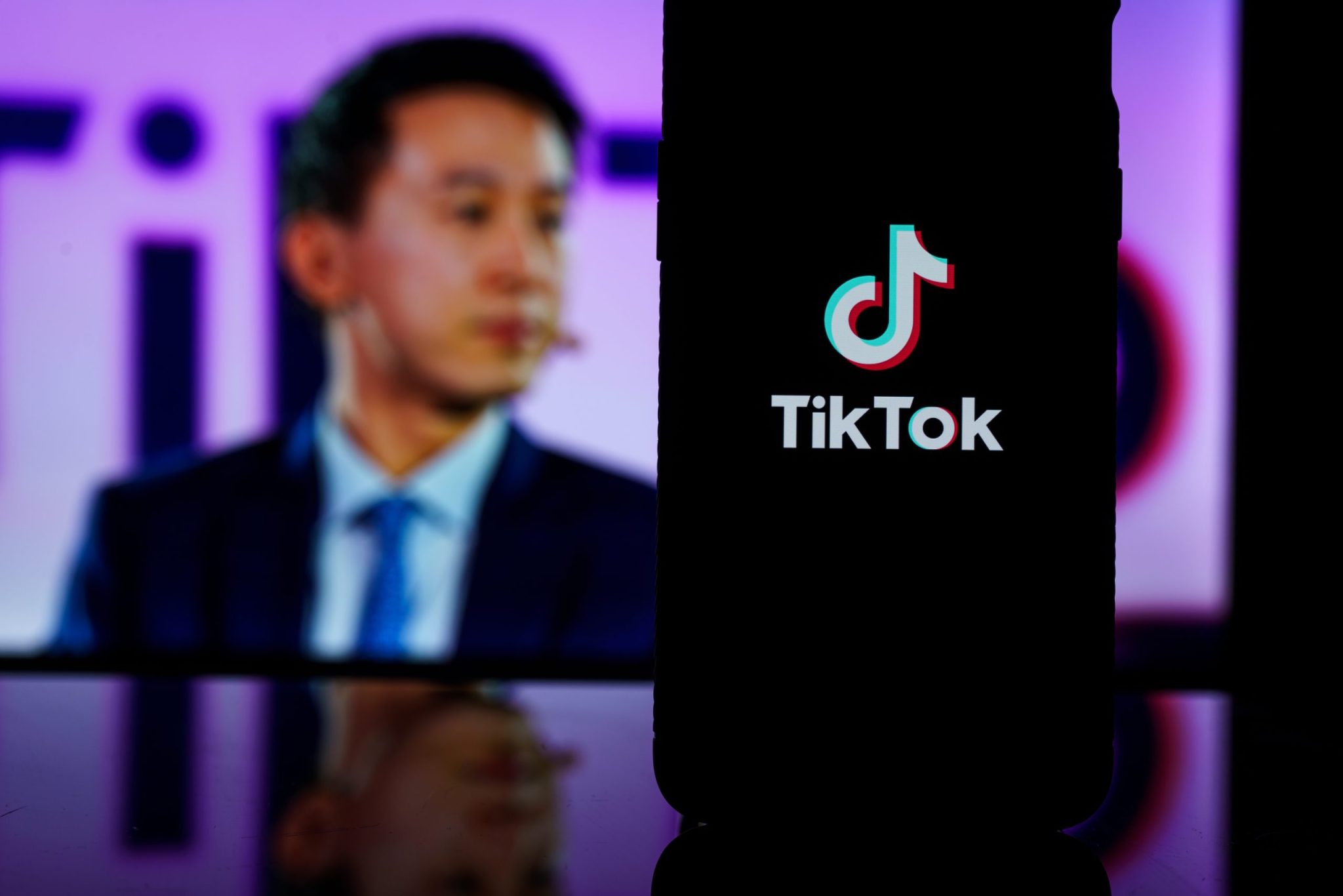 Kaunas, Lithuania - 2023 March 26: TikTok logo on screen and Tik Tok CEO Shou Zi Chew on blurred background. High quality photo