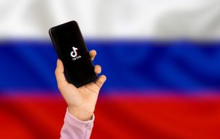 TikTok in Russia - TikTok in mobile with Russian Flag background - tiktok app in russia