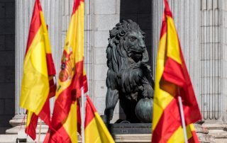 Sculpture of lion in the Congress of Deputies of Madrid with Spanish flags